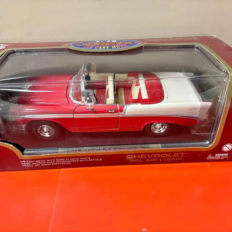Red and white 1956 Belair diecast car model in clear display case