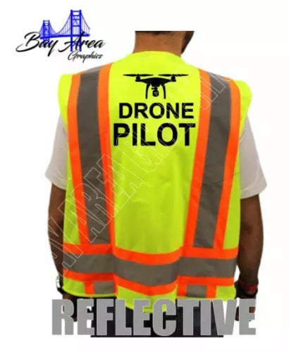 Hi-visibility safety vest in neon yellow with orange reflective strips and 'DRONE PILOT' on back