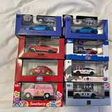 Diecast model cars in retail boxes with clear windows and vehicle graphics