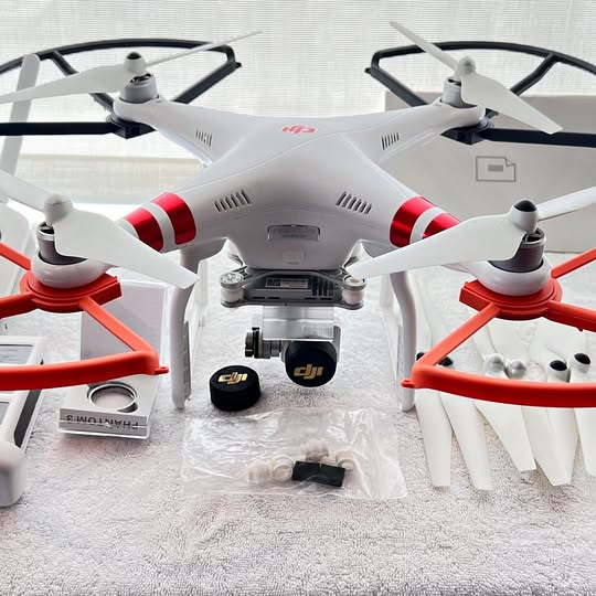 DJI Phantom 3 Advanced drone, white/red accents, propellers and camera housing