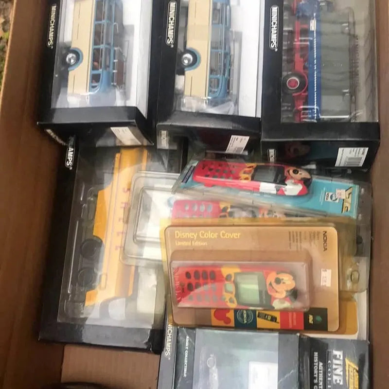 Assorted diecast cars in clear blister boxes, with red and blue models