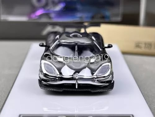 Electroplated silver diecast racing car model, front view with detailed grille and lights