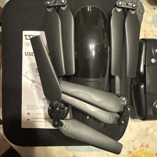 Folded GPS drone with front arms, landing gear, and prop guards
