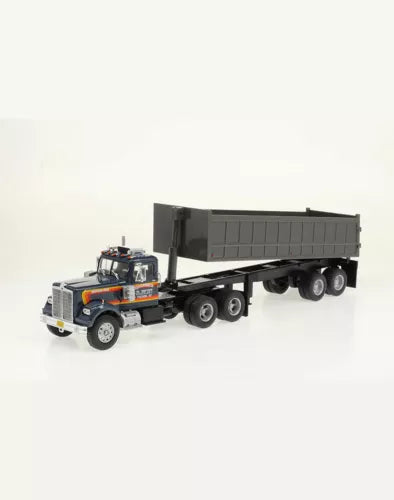 Diecast dump truck model with gray cab, orange accents, black tipping trailer