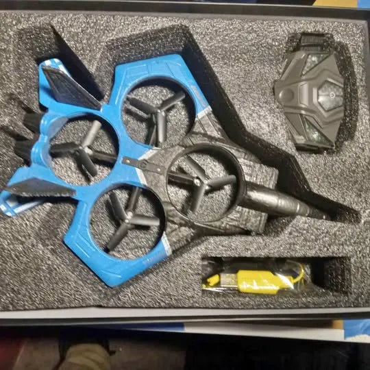 Blue quadcopter drone frame with four propeller guards and central motor mount