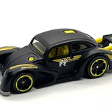 Black die-cast race car with yellow wheels, window decals, and hood detail