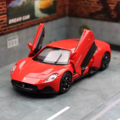 Red metal diecast model car with gullwing doors open, 1/36 scale