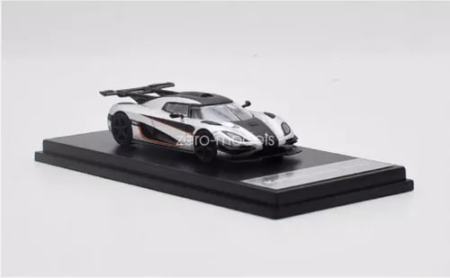 1/64 scale Koenigsegg One:1 silver diecast car toy on display base, black accents