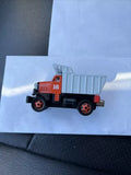 Diecast toy truck with red cab, black wheels, gray cargo, number 16