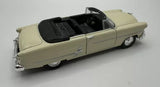 Light beige 1953-style diecast convertible with black soft top, side view.