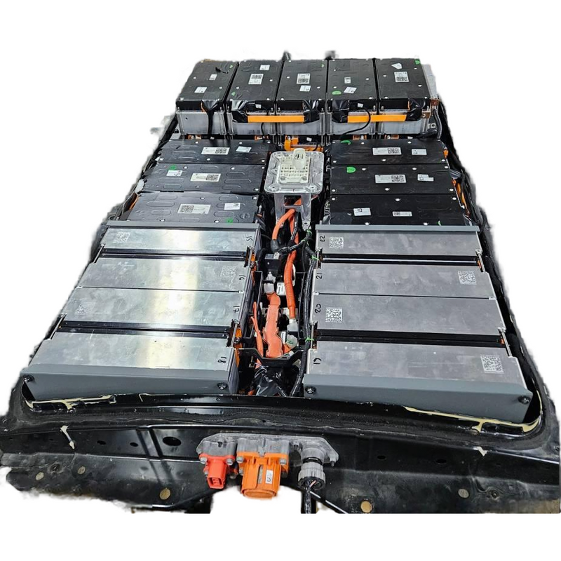 Nissan Leaf EV battery pack with black modules and orange cabling, exposed wiring.