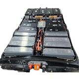 Nissan Leaf EV battery pack with black modules and orange cabling, exposed wiring.