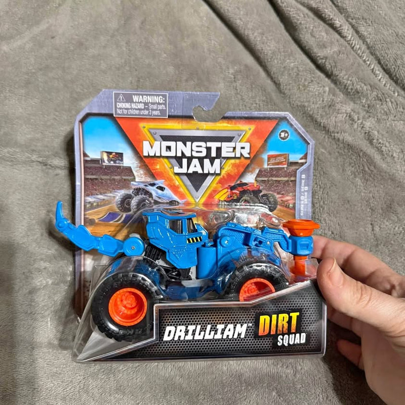 Blue diecast monster truck with orange wheels, in Monster Jam Dirt Squad box