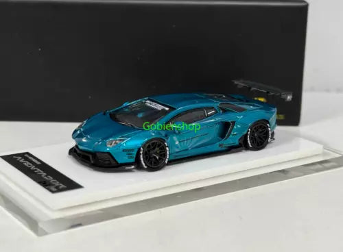 Blue sports car diecast model with open-wheel styling on display base
