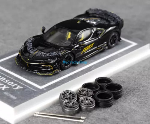 Black diecast racing sports model car with spare tires and rims