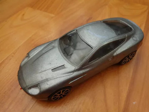 Die-cast sports car model, metallic gray with black wheels and hood detail