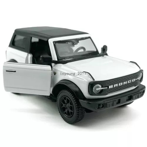 White diecast Ford Bronco model car with open driver door and black grille