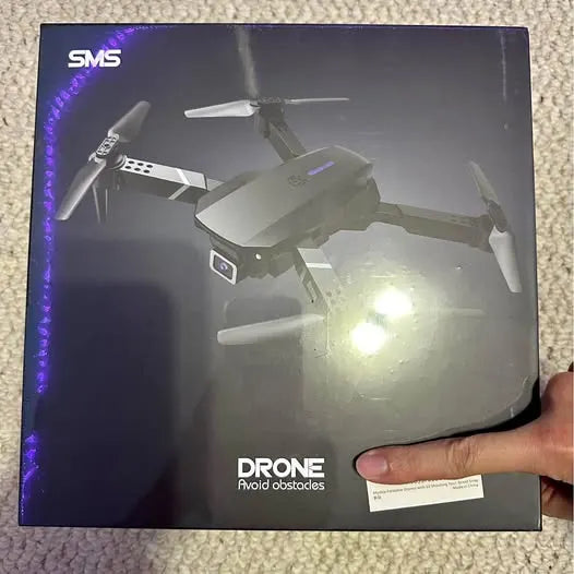 Drone retail box showing multi-rotor drone with LED light