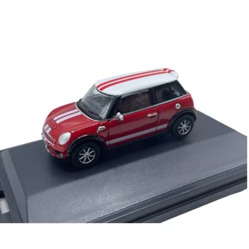 Red diecast mini car with white roof and silver details, side view on display base