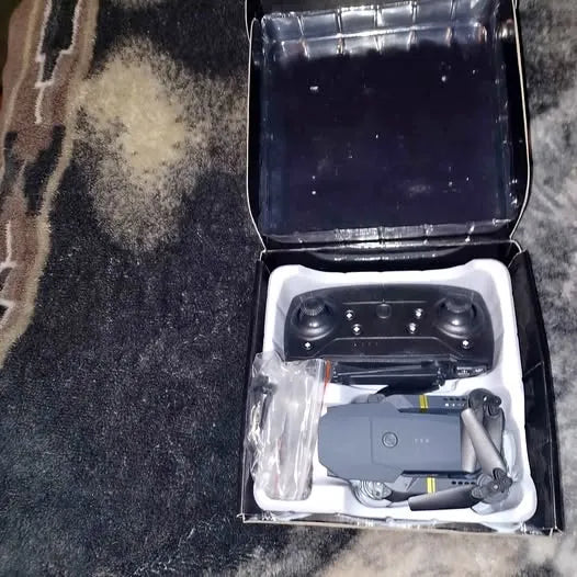 Foldable drone in open case, with propeller guards and controller inside