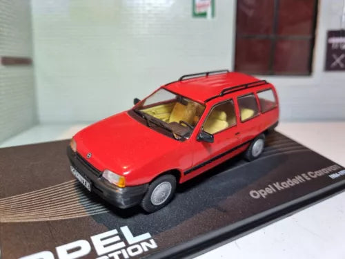 Red diecast station wagon model car with black trim and roof rails
