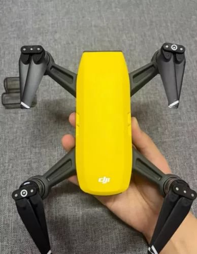 Yellow DJI Spark drone body with four propeller arms
