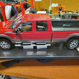 Red and gray diecast Ford F-350 pickup with side steps, chrome wheels, bed detail