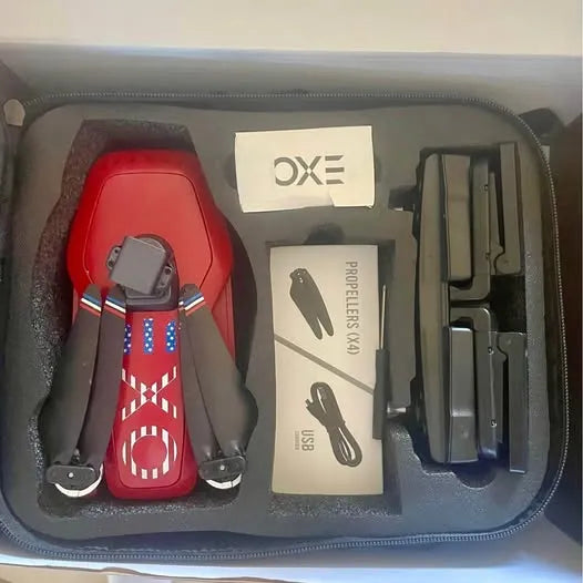 Red drone with attached gimbal stand, propeller set and controller in hard case