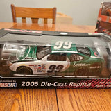 Die-cast replica race car in retail box, green with #99 on hood