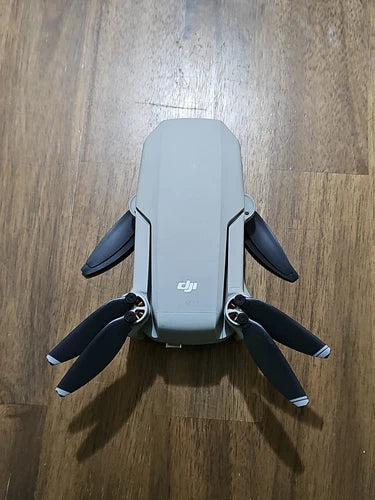 DJI Mavic Mini drone with folded propellers, light gray body