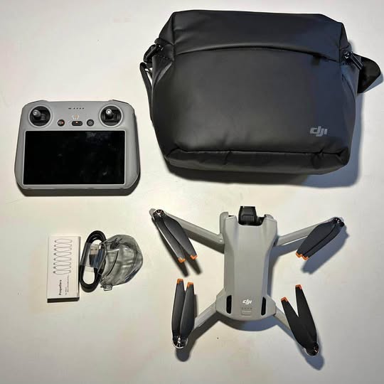 DJI Mini 3 drone kit with RC controller screen, carrying case, propellers and cables