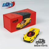 Yellow diecast race car model with red presentation box, BBR and Moxtoys logos visible