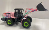 Diecast wheel loader model toy with black cab, pink floral body, lime green tires, front bucket