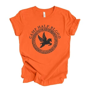 Orange crew-neck graphic T-shirt with circular camp logo and bird emblem