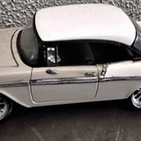 Diecast 1963 Corvette split-window model car, white body with black roof, side view