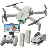 Gray quadcopter drone with camera, green LED light, remote controller, and phone screen view