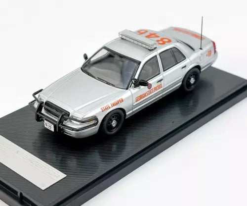 Light gray police patrol diecast car model with roof lights, front 3/4 view