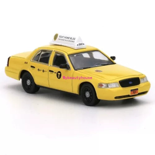 Yellow 1:64 diecast metal taxi model car, front three-quarter view
