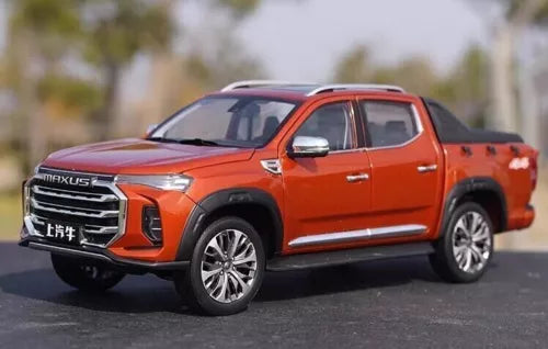 Orange diecast off-road pickup truck model with chrome grille and black wheels
