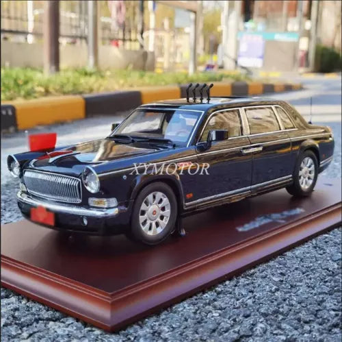 Dark blue 1/18 scale diecast sedan model car with chrome grille and wheels
