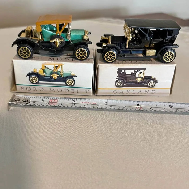 Vintage diecast model cars set, two boxed cars on display with ruler