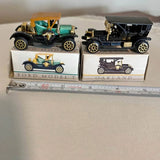 Vintage diecast model cars set, two boxed cars on display with ruler