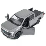 Gray 1:36 Ford F-150 Lightning diecast model car with open front door, black wheels