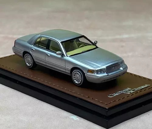 1:64 light blue diecast sedan model on black display base