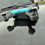 Grey and blue quadcopter drone with four propellers and gimbal camera mount