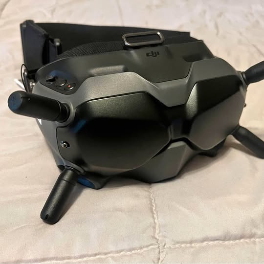 DJI V1 drone goggles with dark gray visor and side control pods