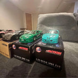 1:24 scale diecast Iroc car set with green and teal cars in black boxes