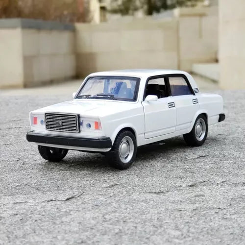 White diecast model car with chrome grille, front three-quarter view, pull-back action