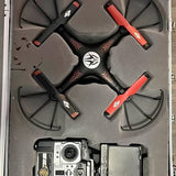 RC drone with four propellers and central camera module, orange accents