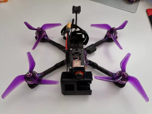 FPV quadcopter drone with purple propellers and front camera module